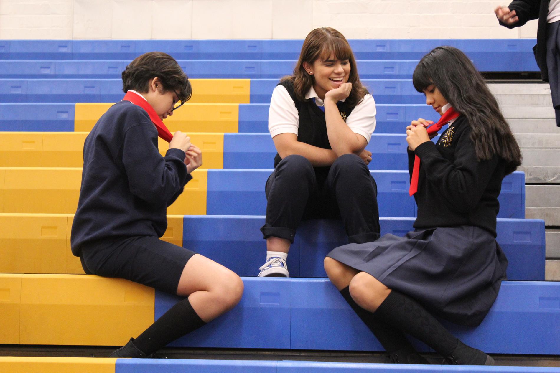 senior helping freshman tie ties