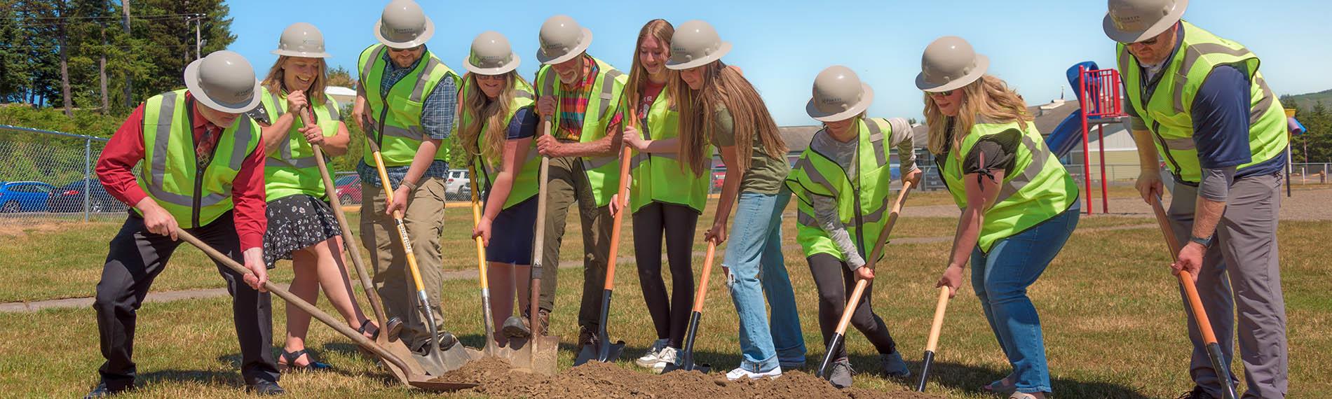Board members and students break ground for new middle school gym site