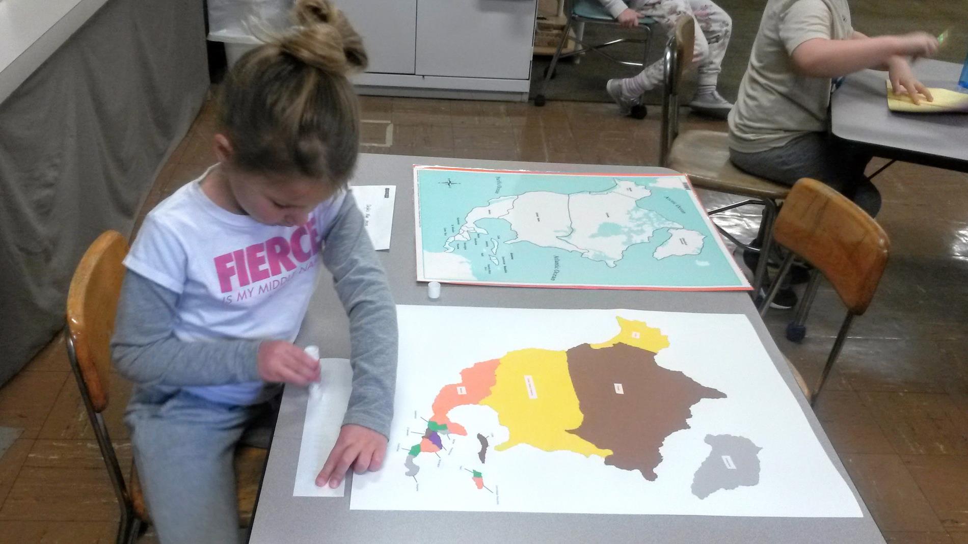 Child working on a map of North America