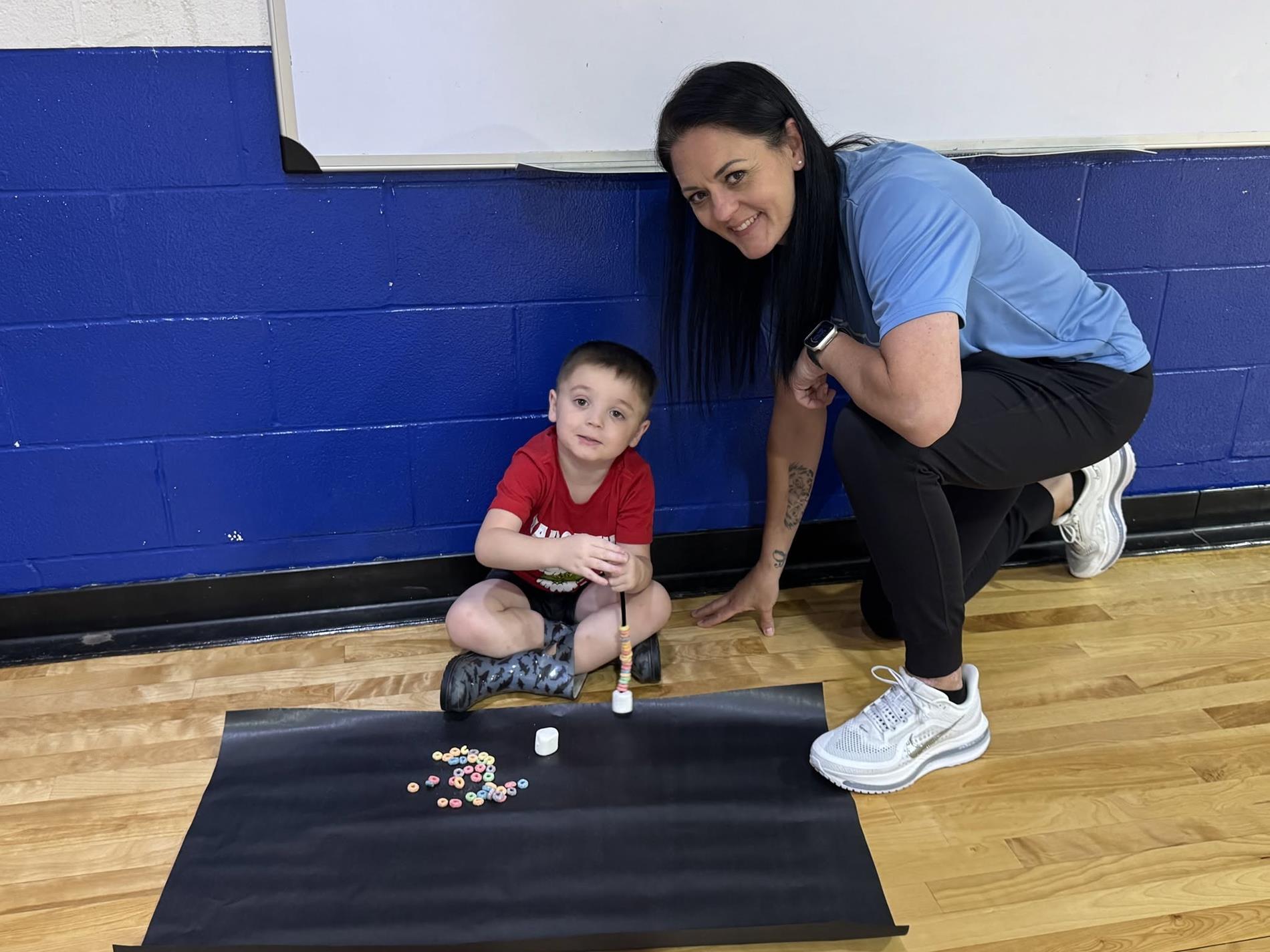 Coach Carr and Student in the gym