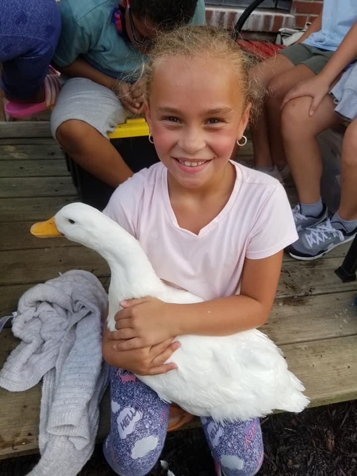 A student holding a goose.