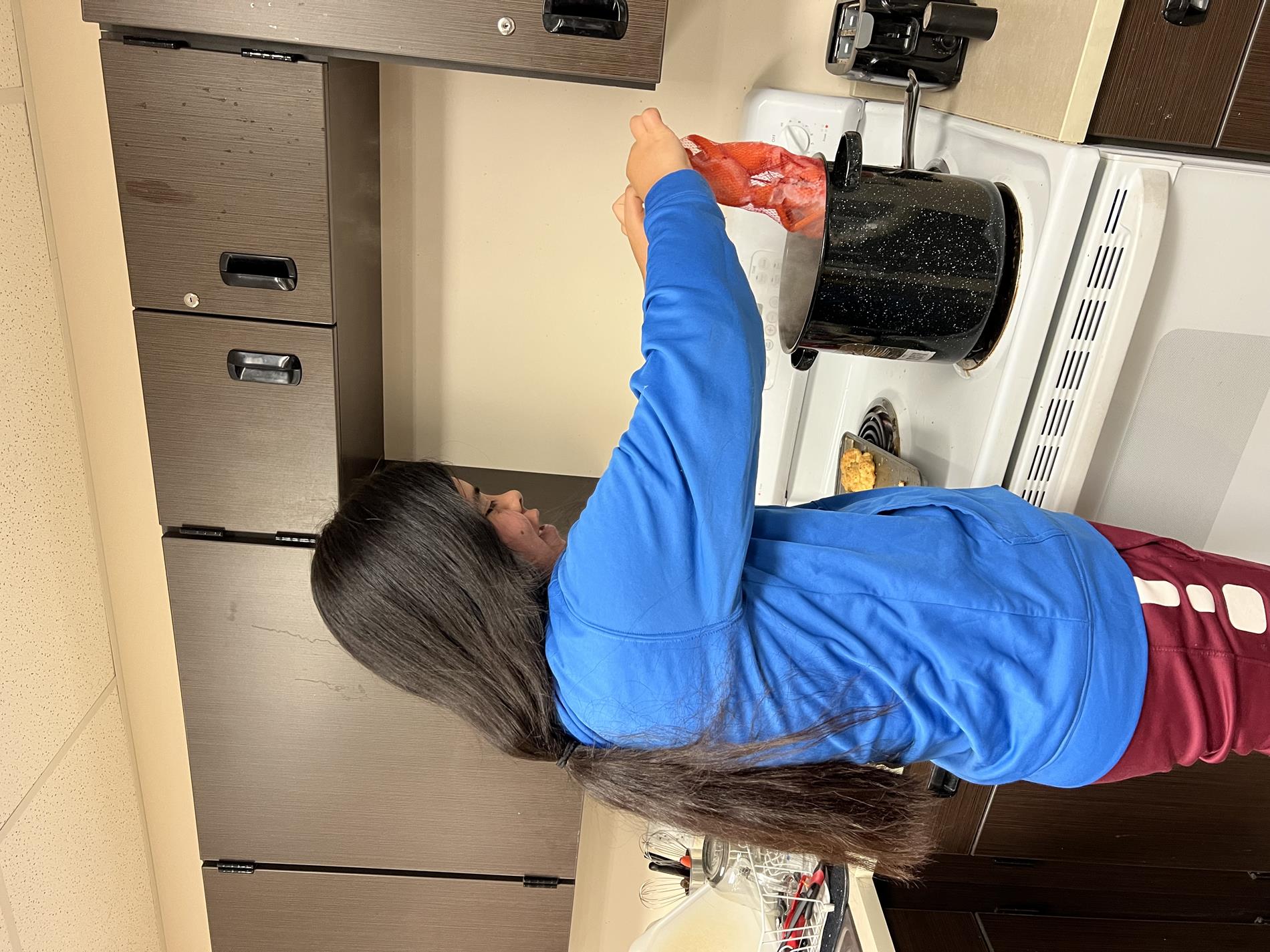 A student boils a lobster.