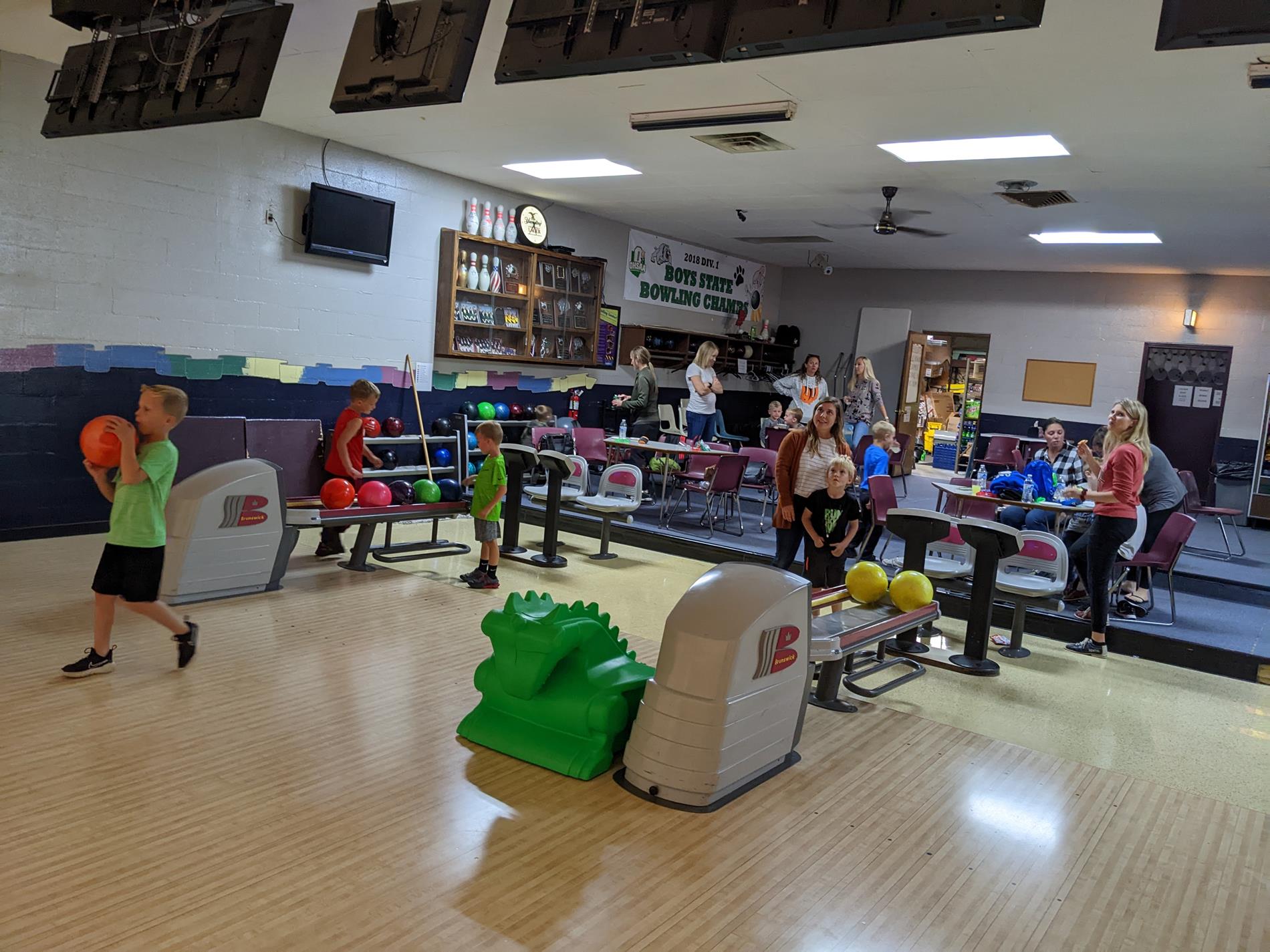 young boys and moms at  bowling alley