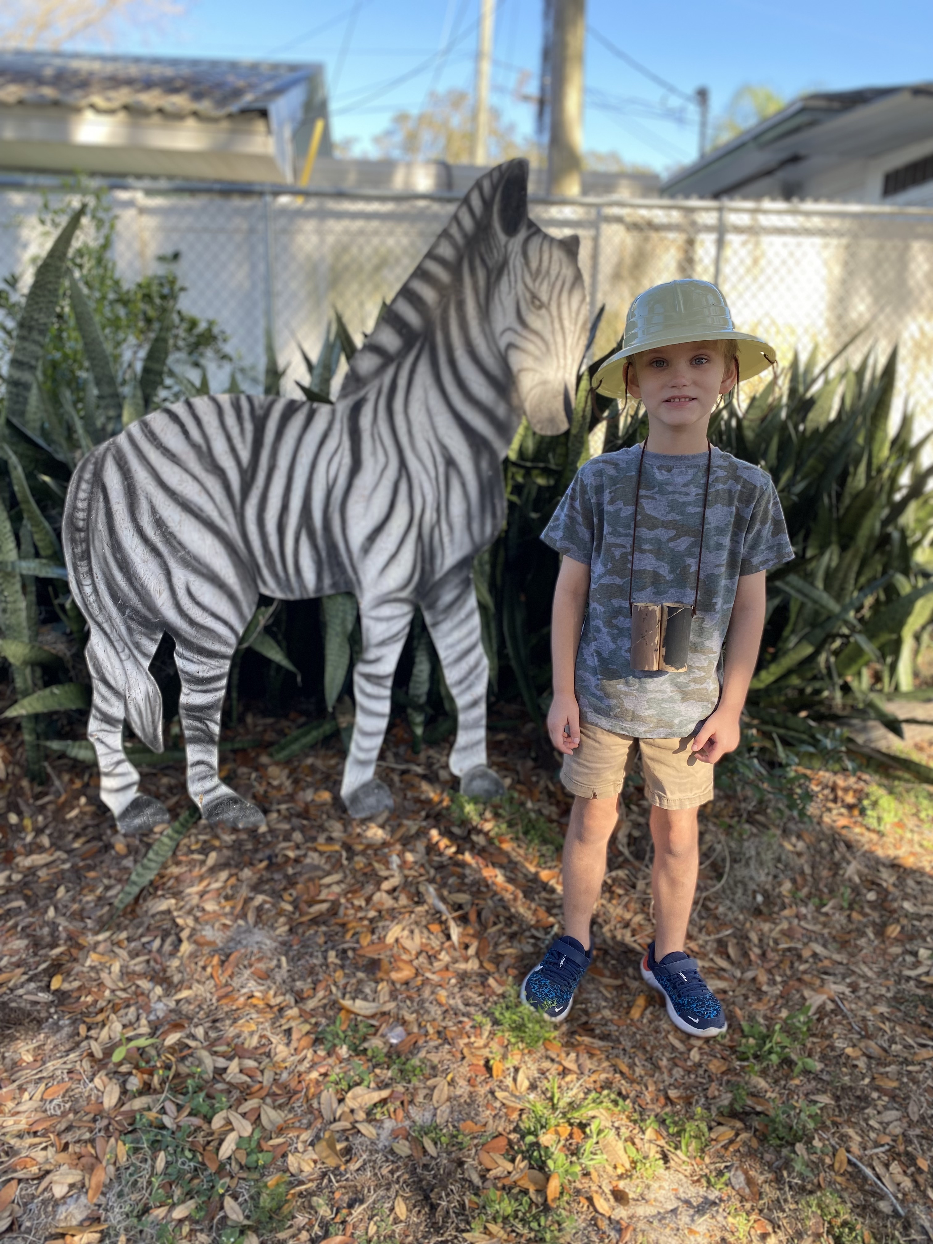 Kindergarten students on a safari with a zebra.