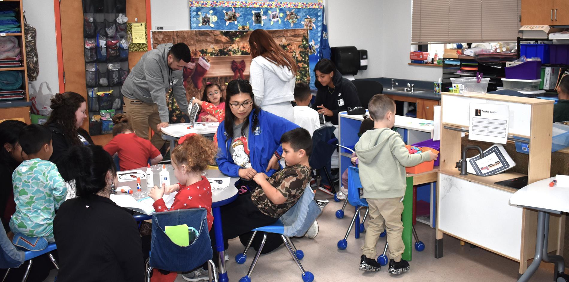 Parents and students working snow globe project