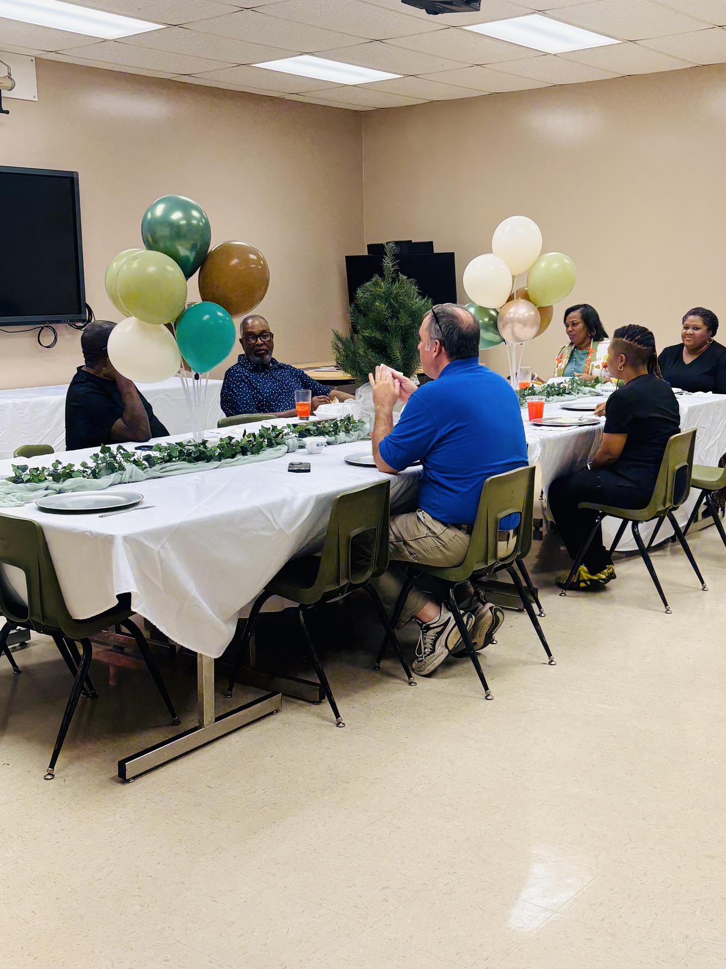 Members of the West Point Consolidated School District Board of Trustees share lunch during a monthly school visit at the West Point Career and Technology Center.