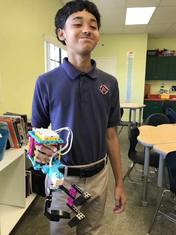 Alex demonstrates his prosthetic arm.