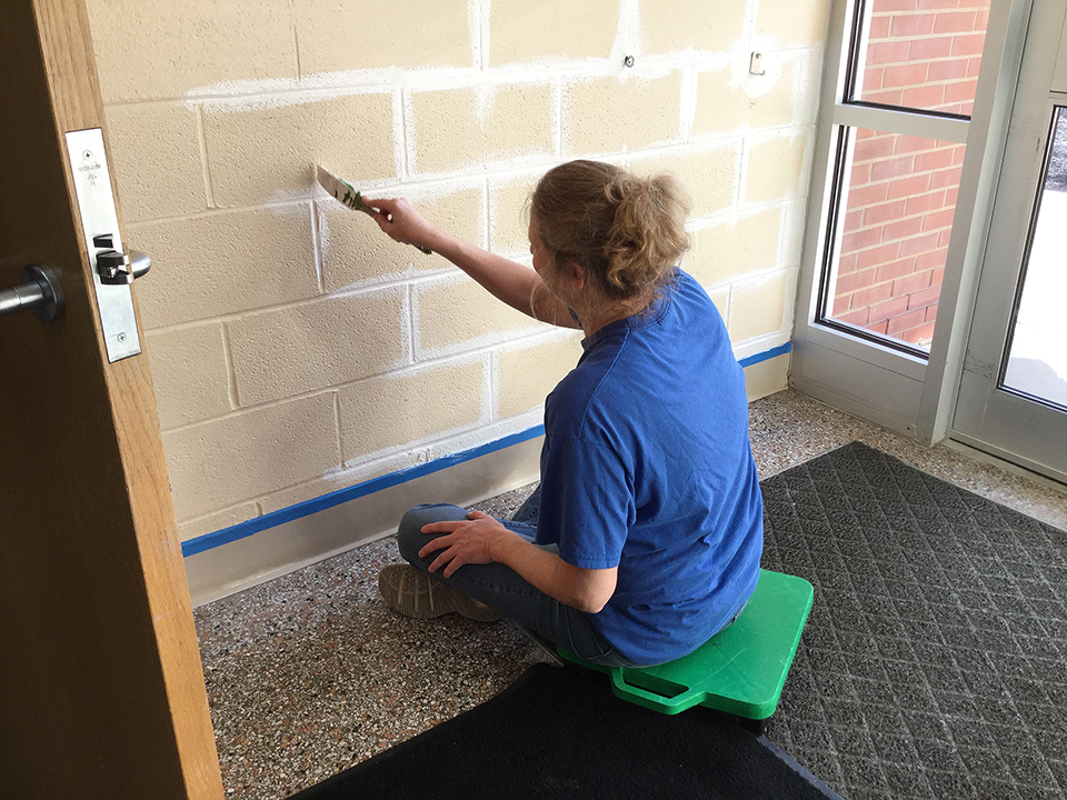 Mrs. Ronshak painting walls