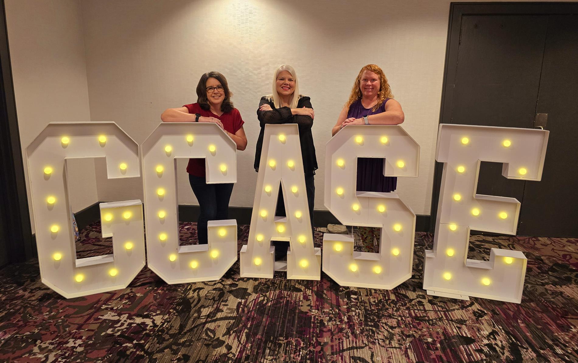 G-CASE members with G-CASE sign