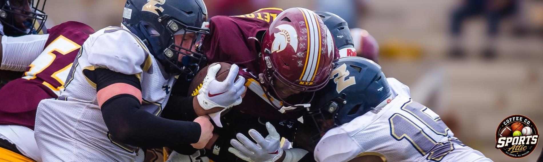 A Trojan Football player carrying the ball