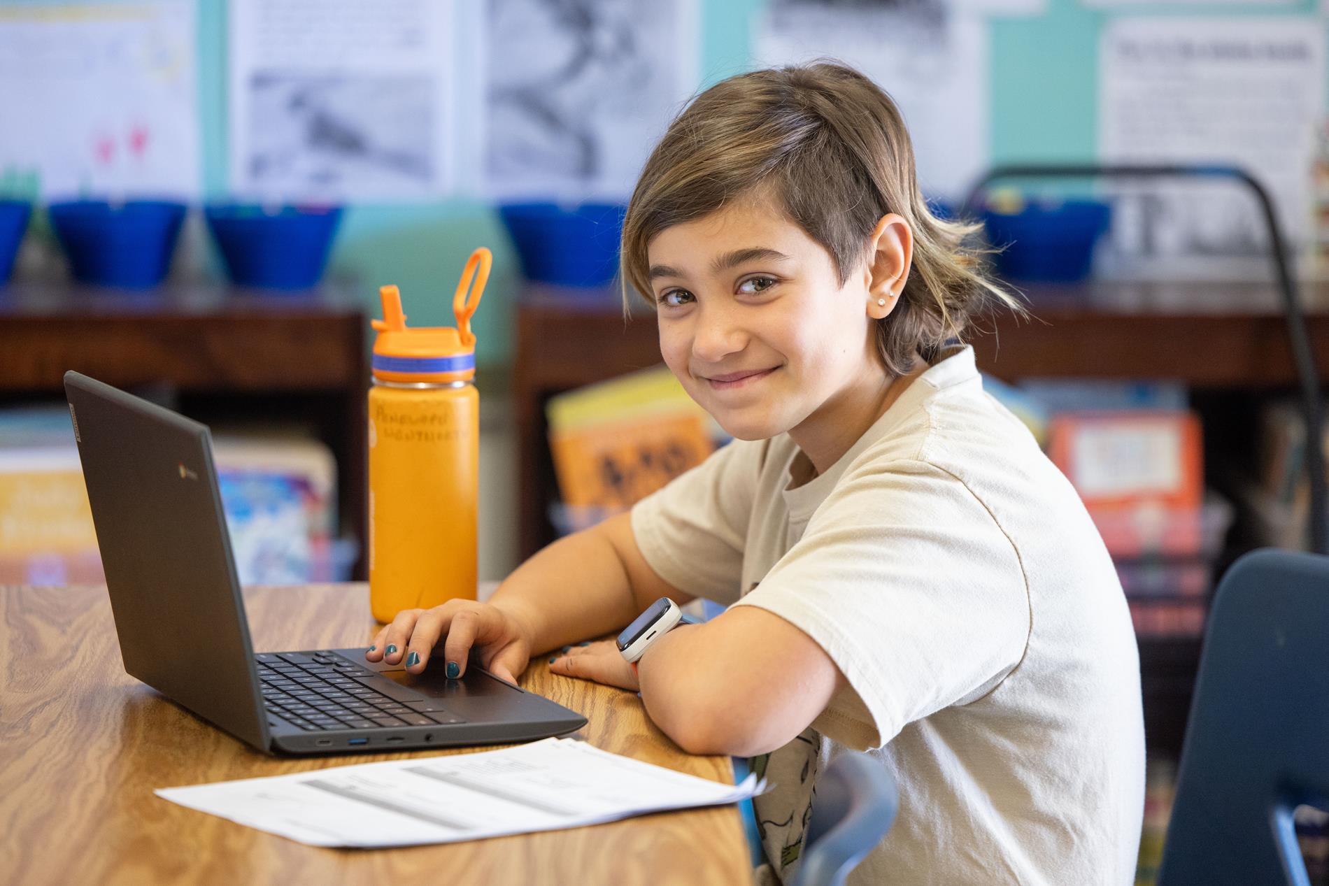 Student at desk smiling