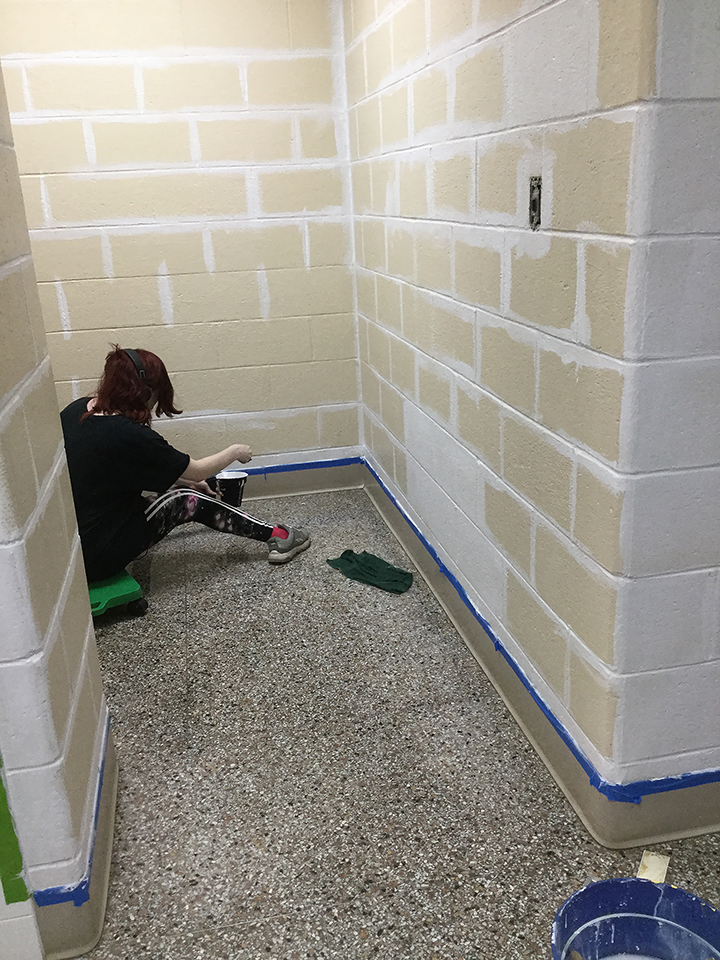 Students volunteering to help paint