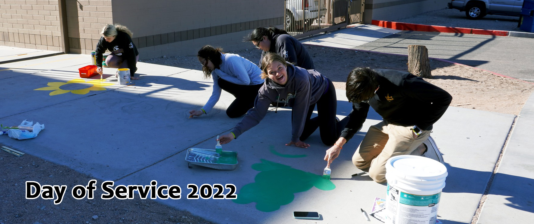 Girls painting sidewalk during 2022 Day of Service