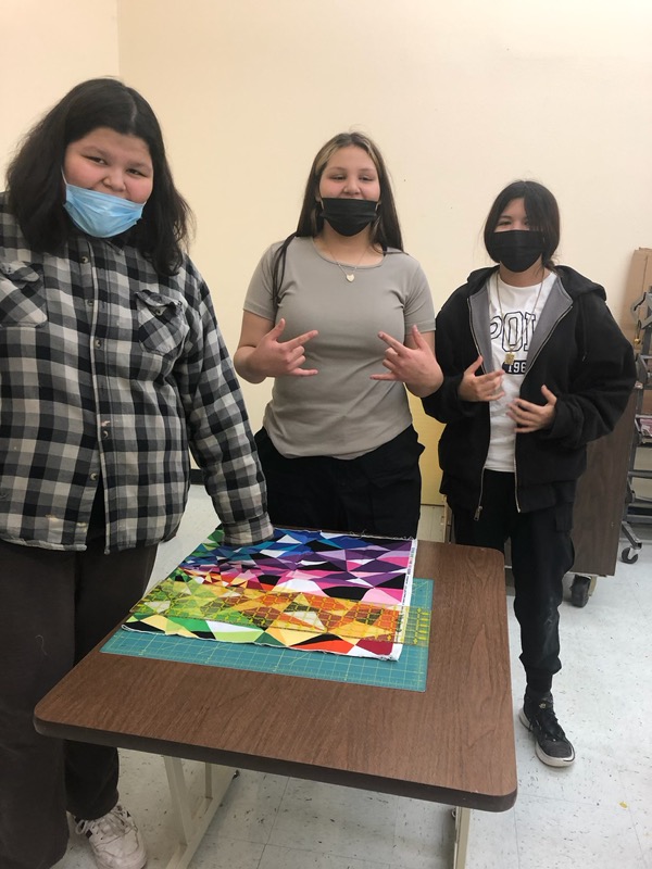 Students helping students to make star quilts 