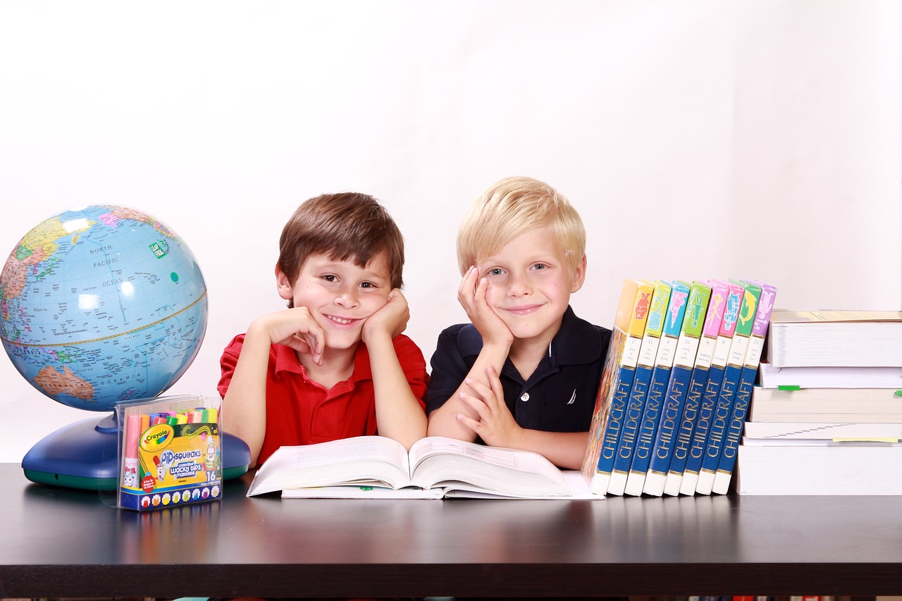 boys with books, markers and globe