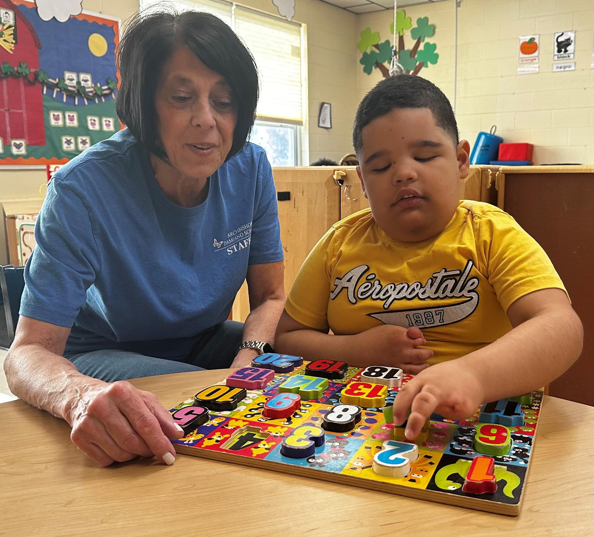 Staff and student with puzzle