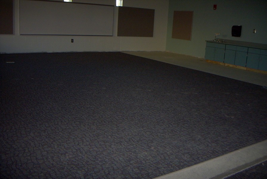 Carpet, dry-erase boards and sink