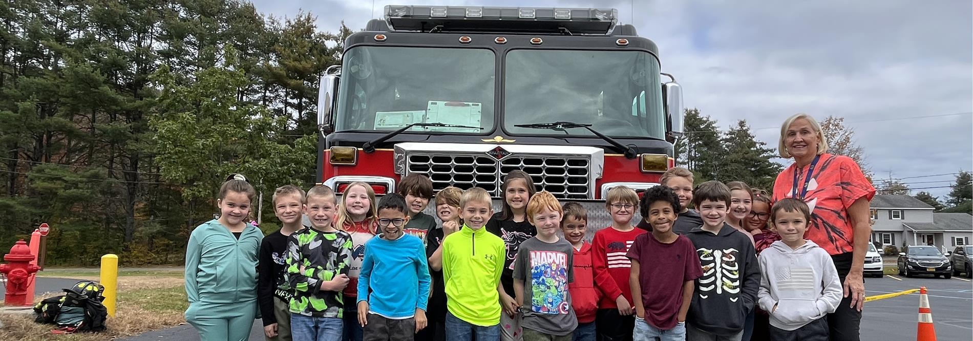 second grade in front of fire truck