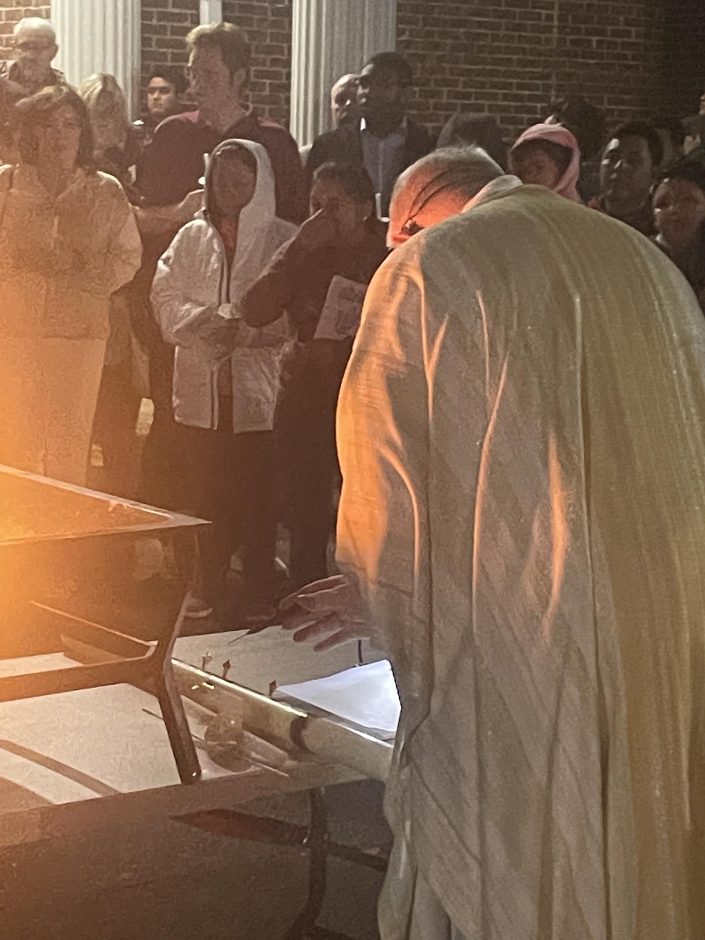 Father Wayne marks the Easter candle