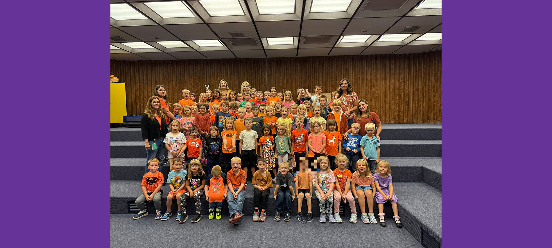 Elementary students dressed in orange to raise awareness for hunger action month