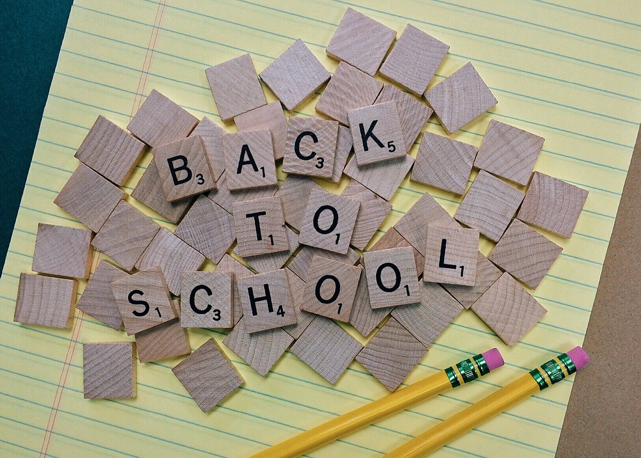 back to school scrabble tiles on notebook paper with pencil