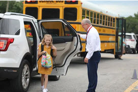 girl greeted at car line 