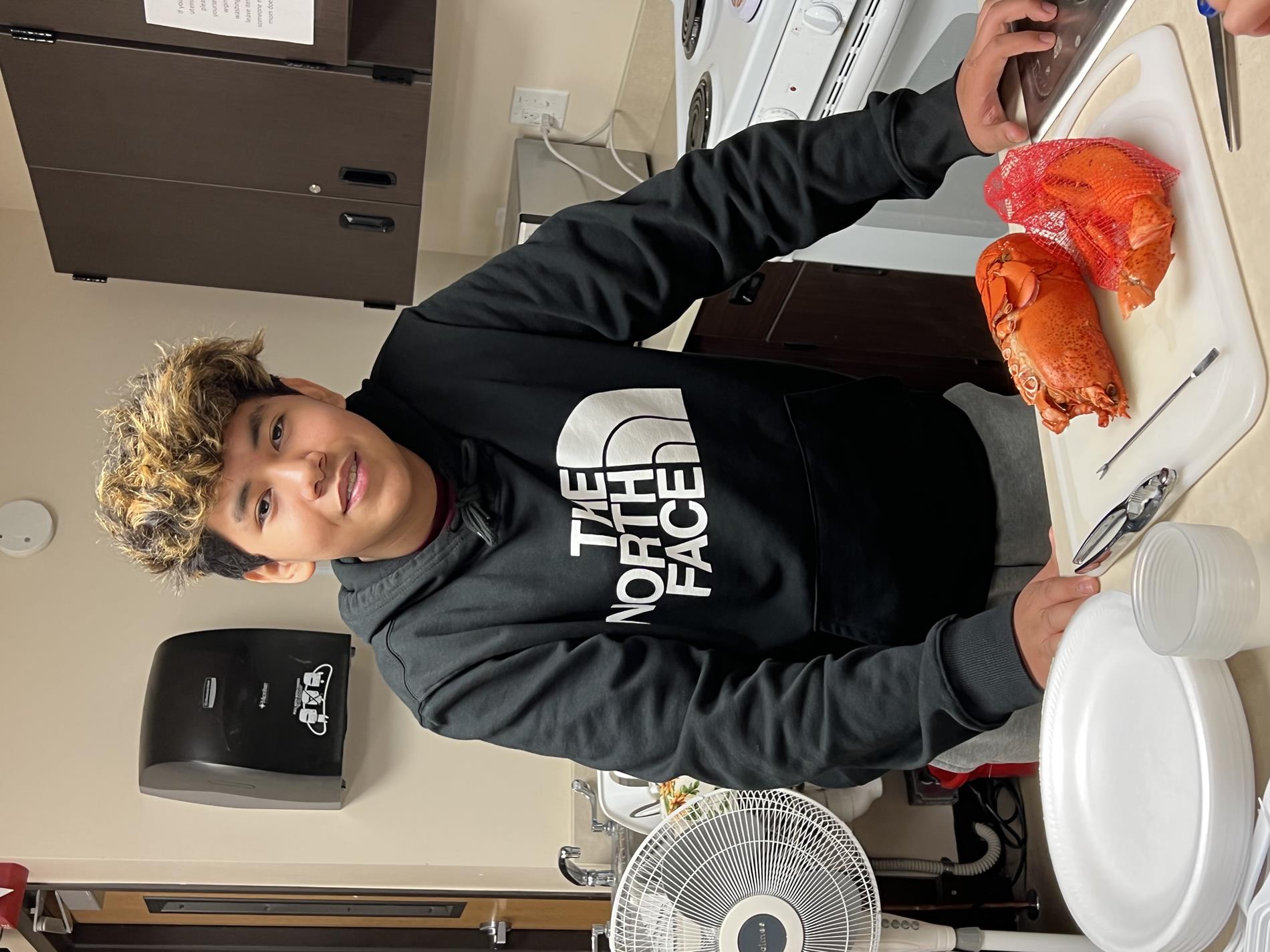 A student volunteer ready to break open the main body of the lobster. 