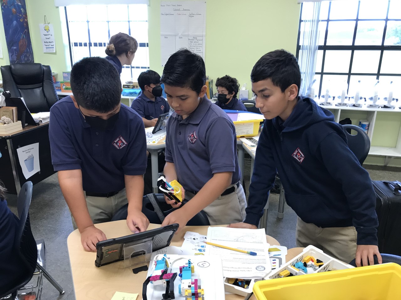 Bradley, Joshua, and Jesus research about children with real-life prosthetics.