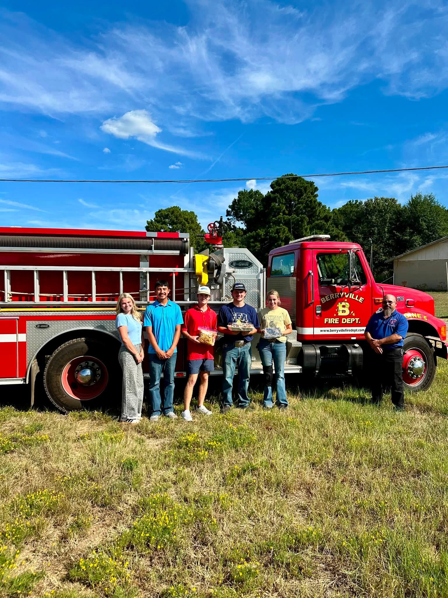 Ag students posing in front of a firetruck 