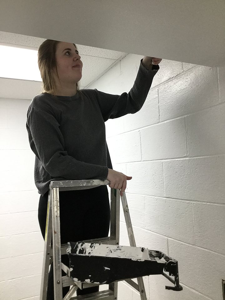Students volunteering to help paint