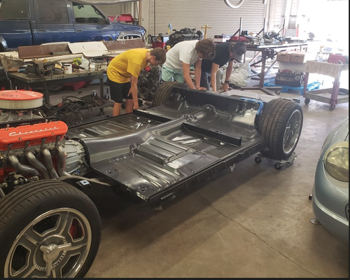 Students work on automobile from in Auto Shop class