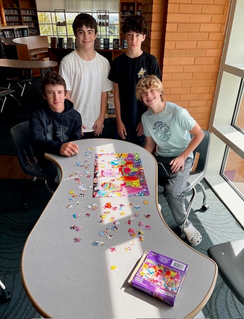 Photo of students working on a library puzzle
