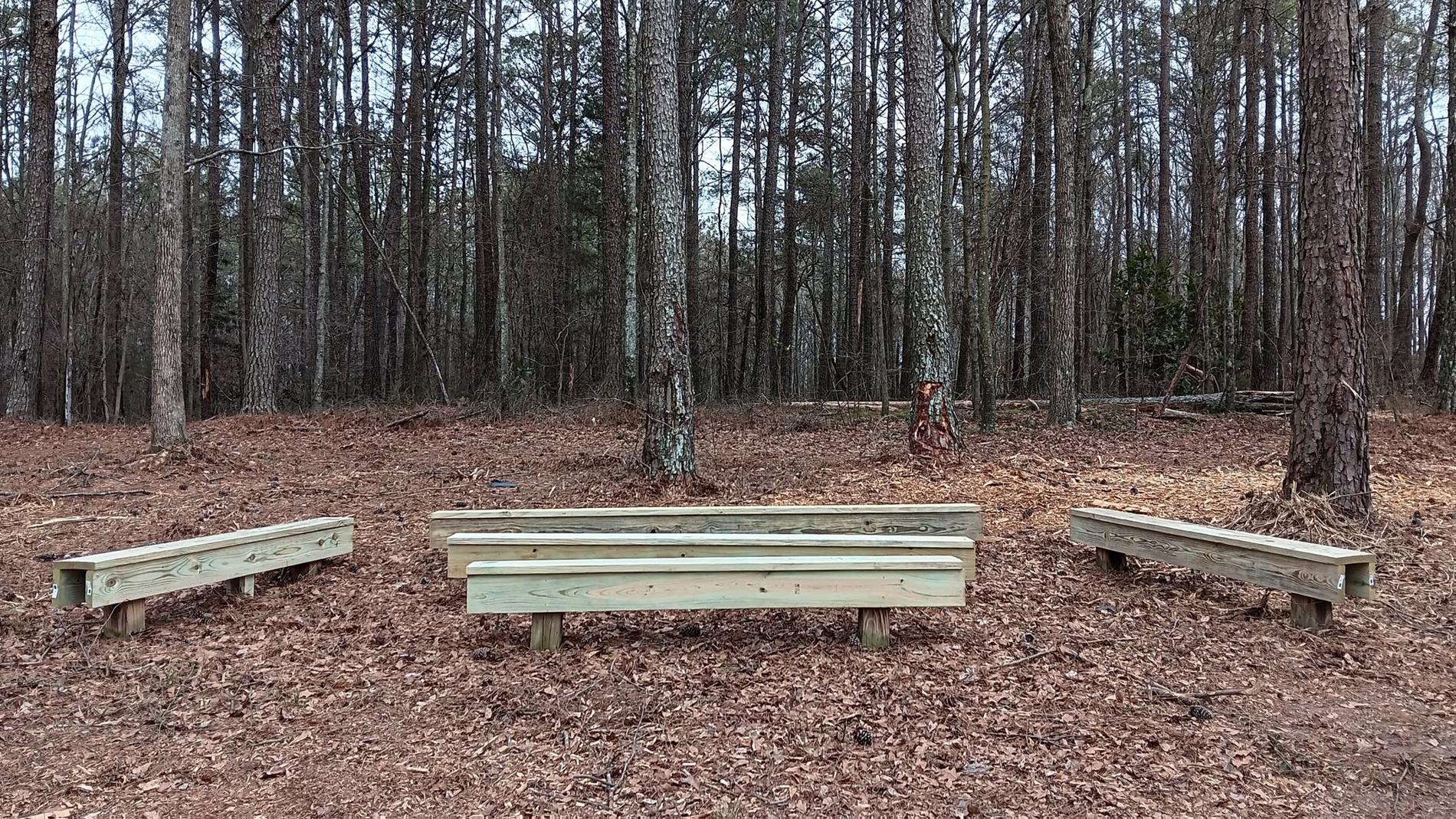 Another area of the outdoor classroom that has been restored (wooden seating area)
