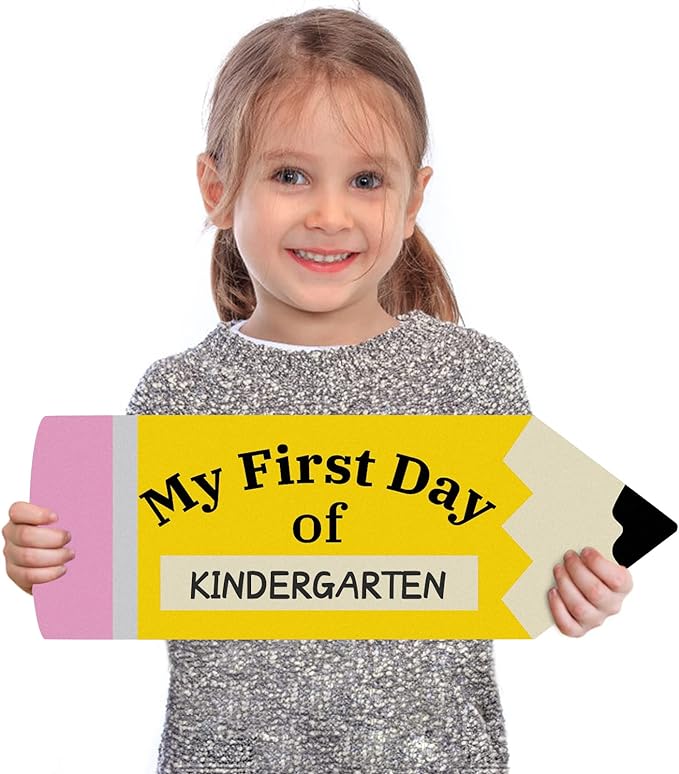 Young girl holding a pencil shaped sign that says "My First Day of Kindergarten."