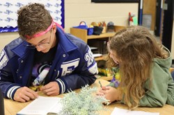 Principles of Education students assist younger students with their classwork