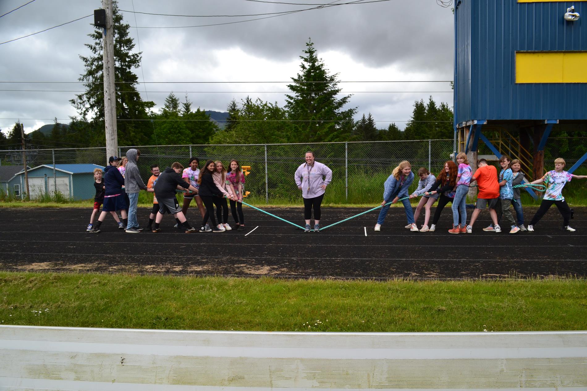 Middle school students and Mrs. Myers getting ready for the tug of war