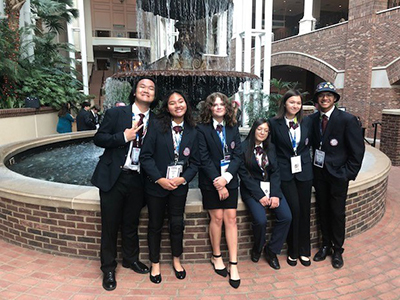 HOSA students standing in front of fountain at conference