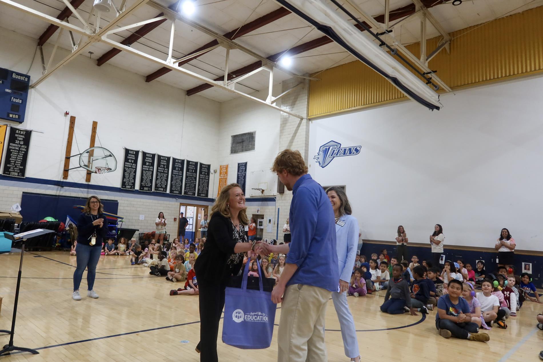 Kathryn Jennings presents an award at a local elementary