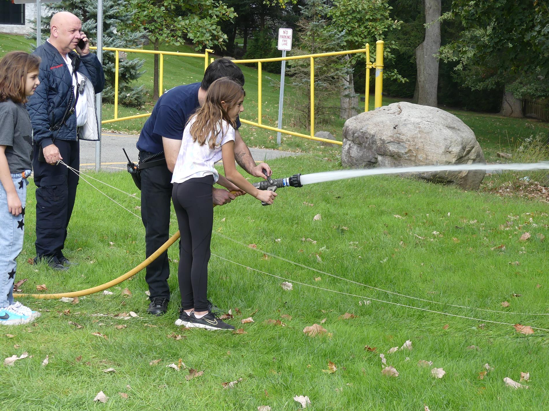 Student learning to use fire hose