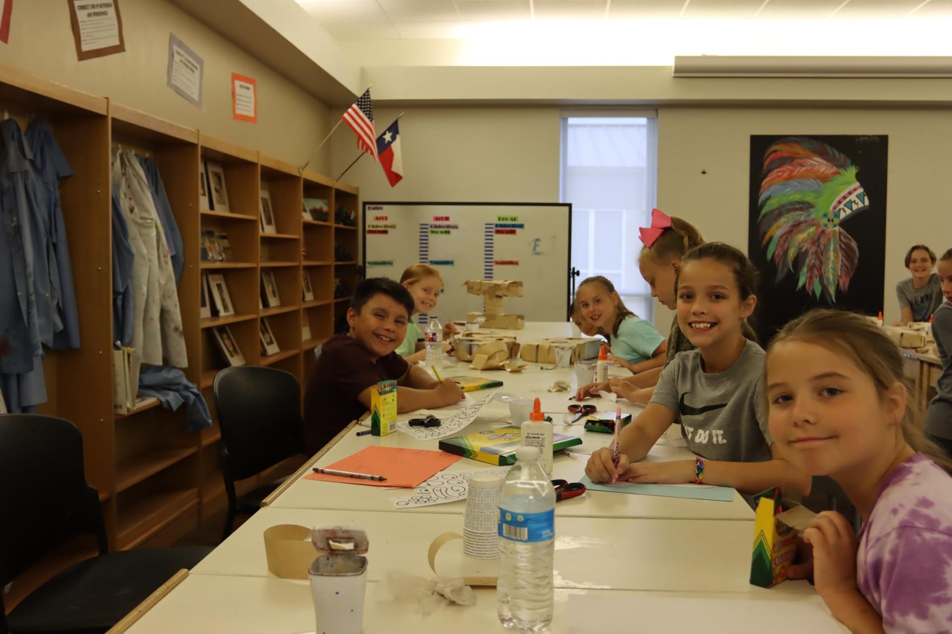 Students showing work at art camp