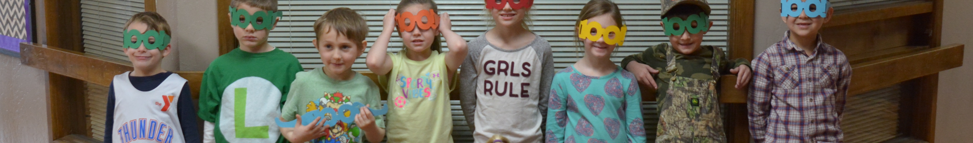 group of young students with paper glasses on