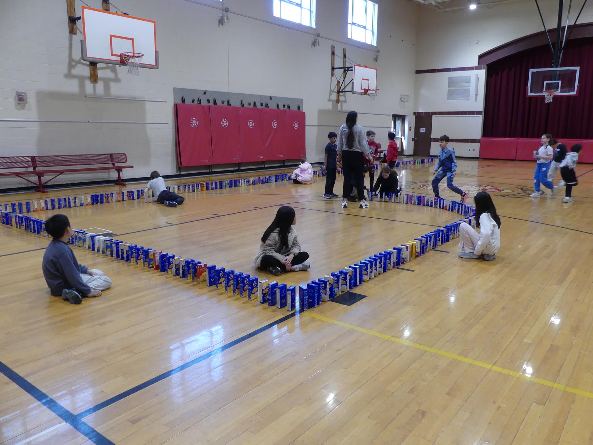Macaroni & Cheese collection shows students and boxes set up like dominos