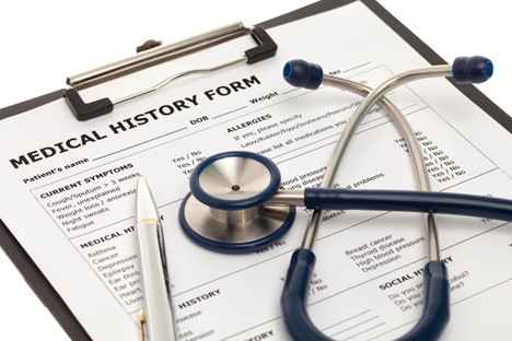 Clipboard with medical history form with a stethoscope and pen on it