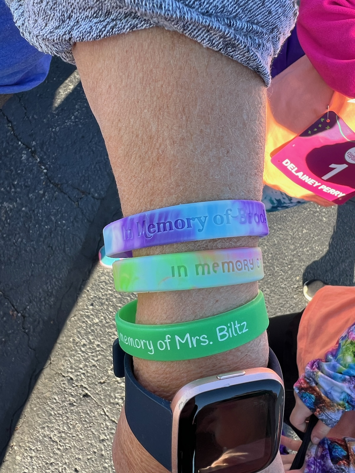 One of the GOTR coaches showing her memorial wristbands. 