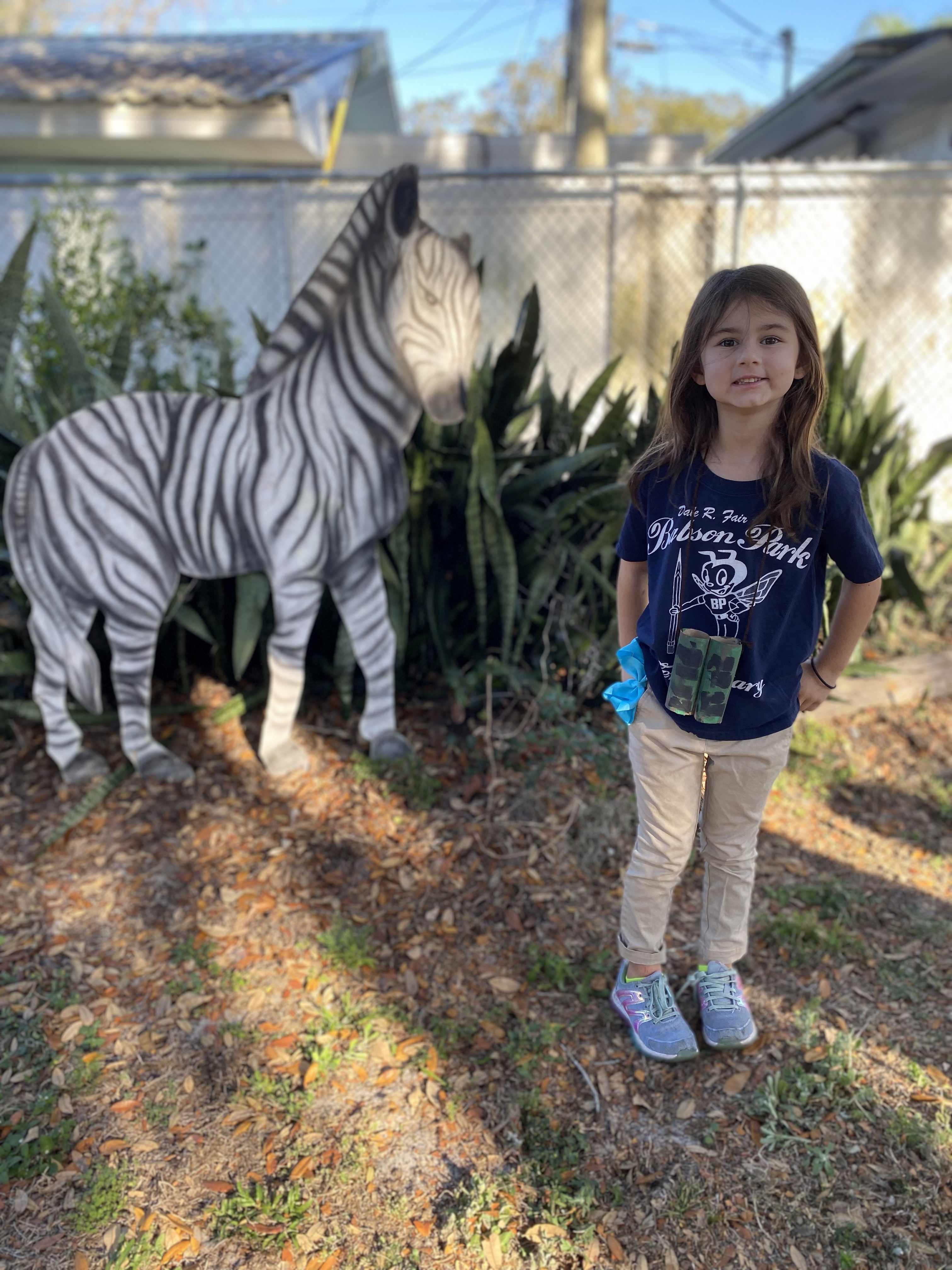 Kindergarten students on a safari with a zebra.