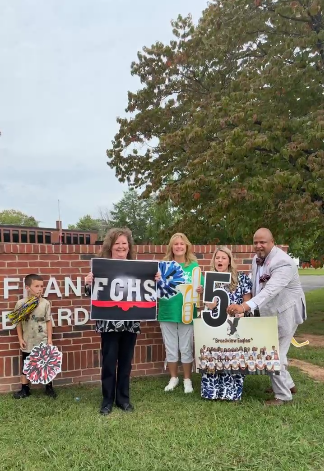 Holman and principals with signs