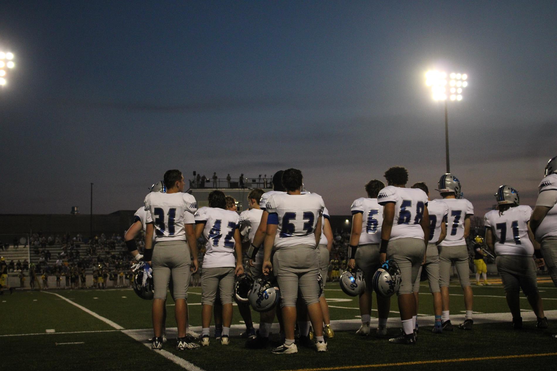 photo of the football team from behind, showcasing their jerseys