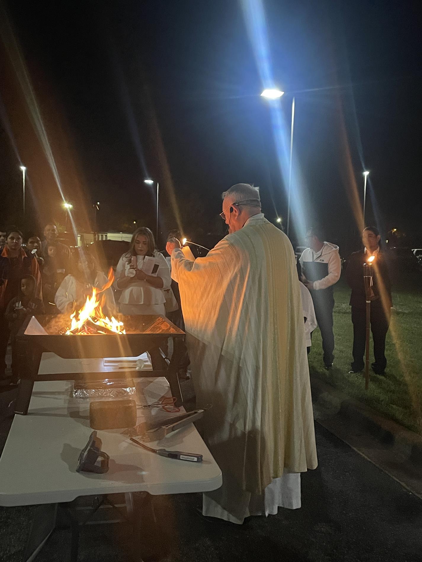 Father Wayne lights the Easter Candle from the Easter fire