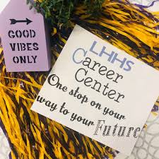 LHHS Career Center - one stop on your way to your future note laying on top of a purple and gold pom pom
