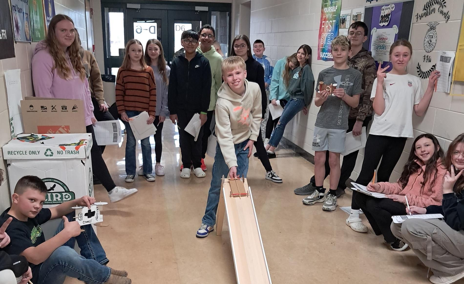 A group of middle school students testing their handmade cars.